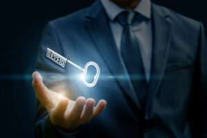 Picture of businessman holding keys, reflecting the keys to success